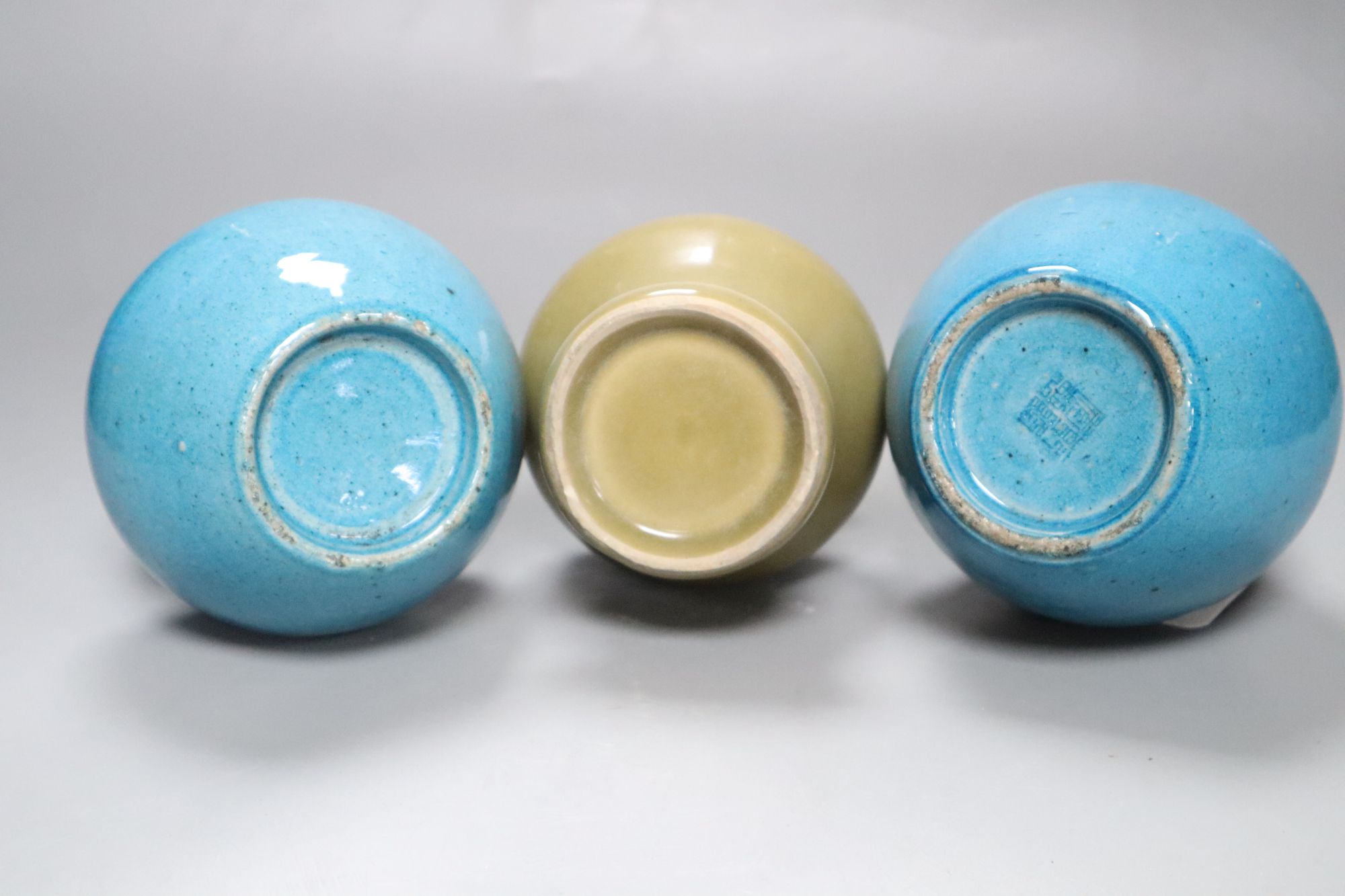Two Chinese turquoise glazed vases and a celadon glazed bottle vase, height 20cm